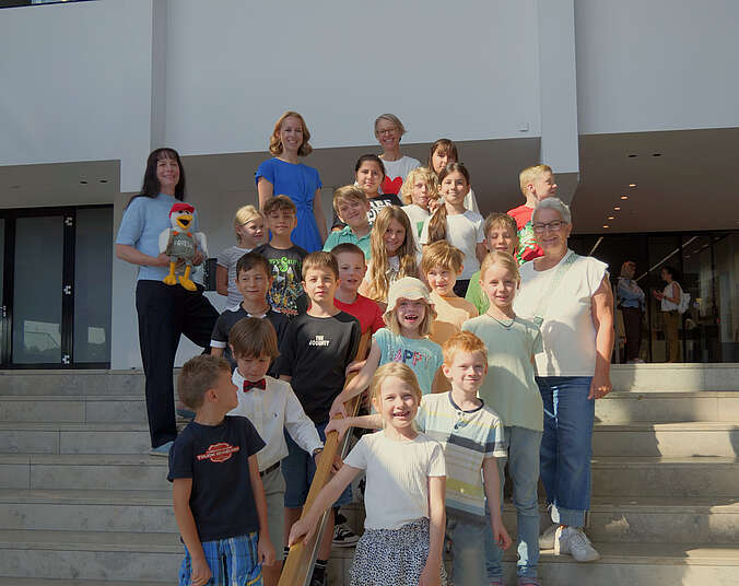 Schulklasse FU1b und Erwachsene von links nach rechts: Jutta Kubalczyk mit Lesemöwe Frieda, Amtsleiterin Dr. Anita Huhn, Lehrerin Petra Wenger und Erzieherin Iris Hartmann (Foto: Medienhaus am See)